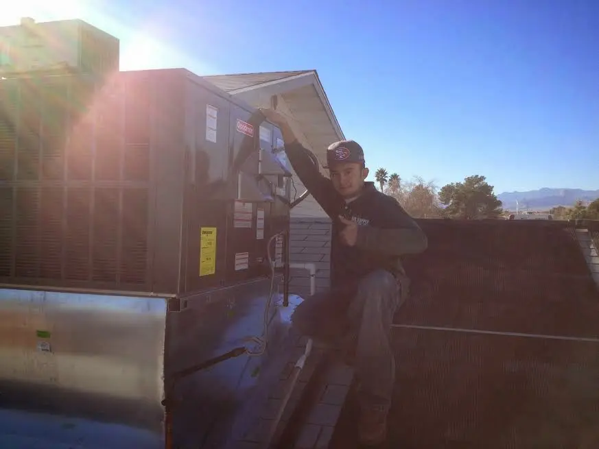 HVAC technician performing Boiler Repair on a rooftop unit in Hopewell